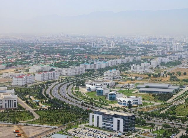 A wide avenue lined with white marble buildings in Ashgabat